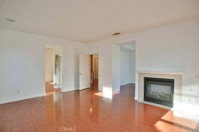 unfurnished living room featuring hardwood / wood-style floors