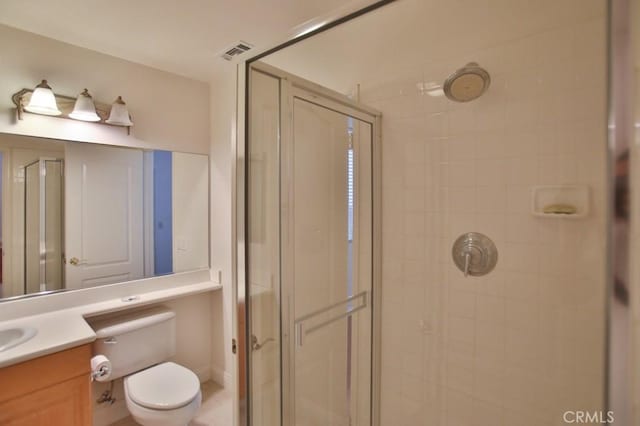 bathroom featuring vanity, toilet, and walk in shower