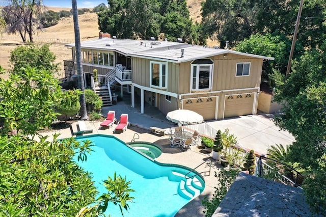 rear view of house with a patio and a garage