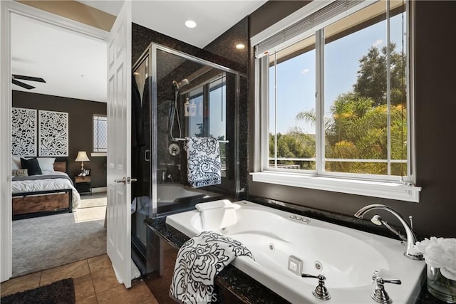 bathroom with separate shower and tub, a healthy amount of sunlight, and tile patterned floors