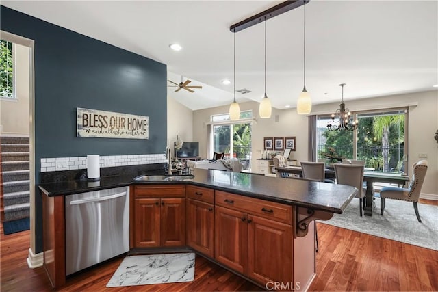 kitchen featuring lofted ceiling, sink, dark wood-type flooring, dishwasher, and decorative light fixtures