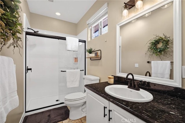 bathroom with vanity, toilet, tile patterned flooring, and a shower with door