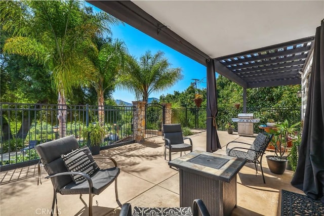 view of patio / terrace with area for grilling, an outdoor fire pit, and a pergola