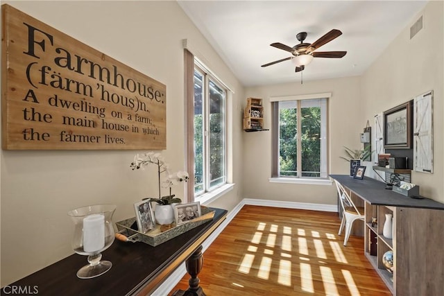 home office featuring hardwood / wood-style flooring and ceiling fan