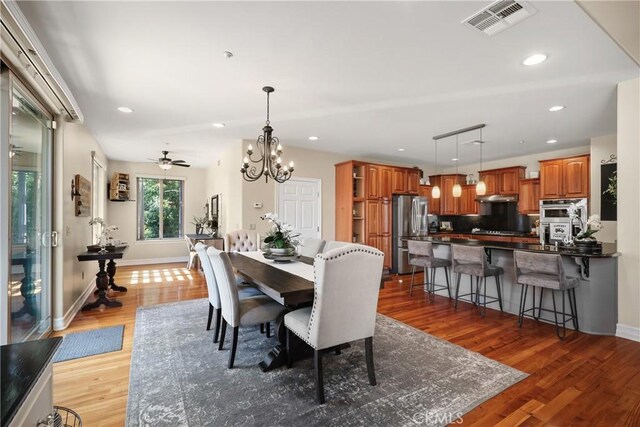 dining space featuring hardwood / wood-style floors and a notable chandelier