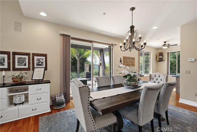 dining space featuring a notable chandelier and dark hardwood / wood-style flooring