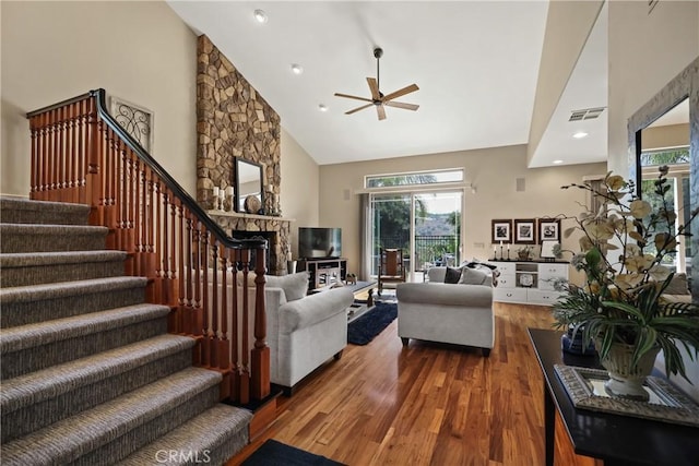 living room with a fireplace, high vaulted ceiling, dark hardwood / wood-style floors, and ceiling fan