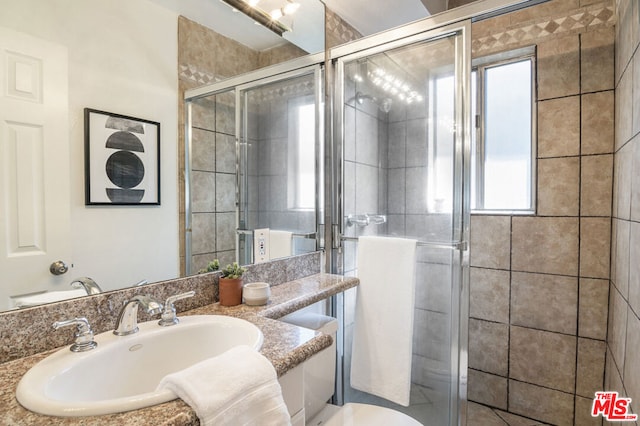 bathroom featuring vanity and a shower with shower door