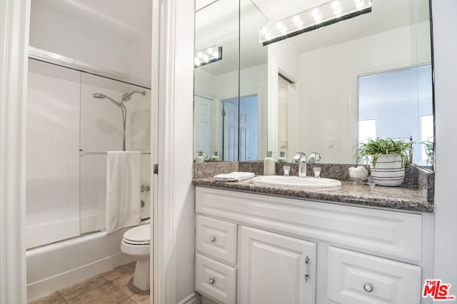 full bathroom featuring tile patterned floors, vanity, toilet, and enclosed tub / shower combo