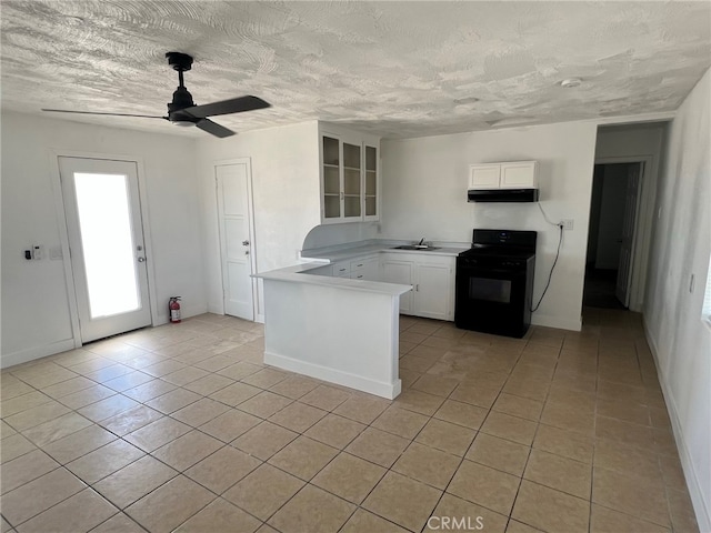 kitchen featuring ceiling fan, white cabinets, light tile patterned floors, sink, and gas stove