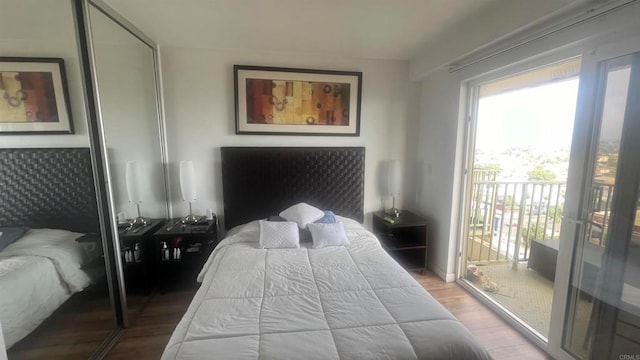 bedroom featuring a closet, access to outside, and wood-type flooring