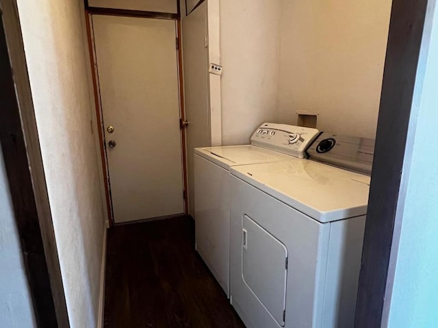 laundry area with washer and clothes dryer and dark wood-type flooring