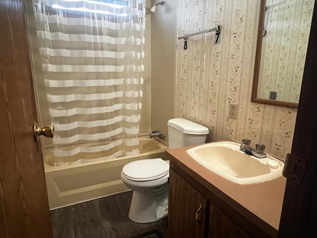 full bathroom featuring hardwood / wood-style floors, vanity, shower / tub combo, and toilet