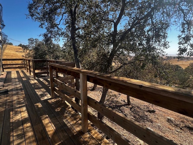 wooden terrace featuring a rural view