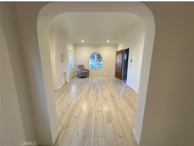 hallway with light hardwood / wood-style flooring