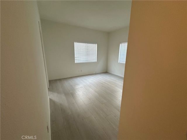 spare room with light hardwood / wood-style floors