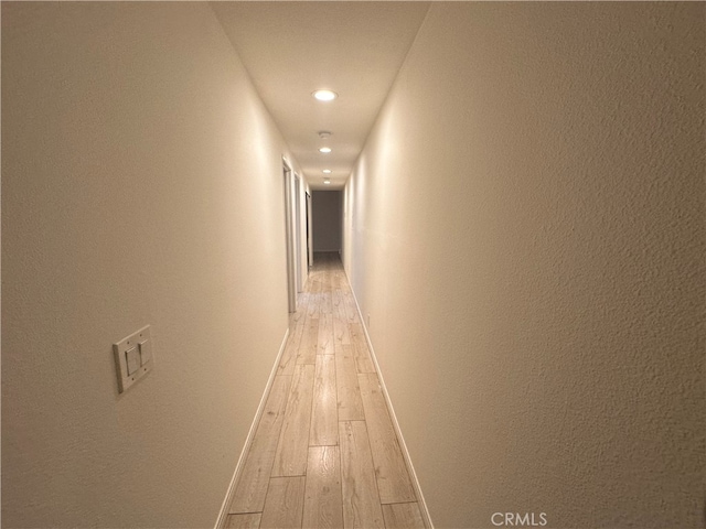 corridor with light wood-type flooring