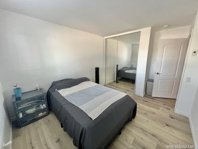 bedroom featuring a closet and light wood-type flooring