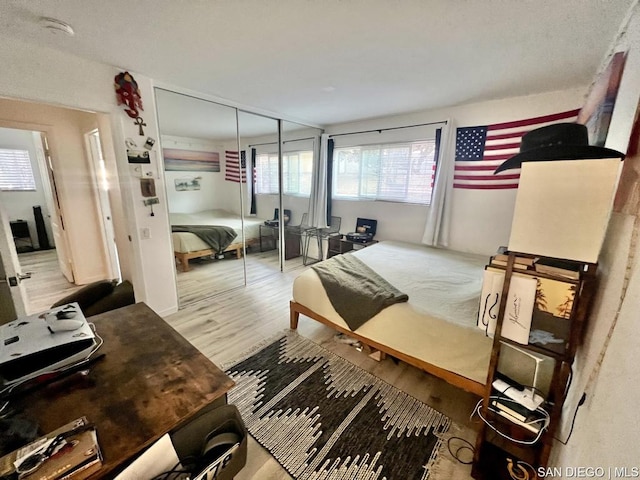 bedroom featuring light hardwood / wood-style flooring and a closet