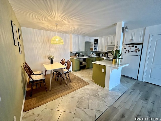 kitchen with a kitchen island, decorative light fixtures, white cabinetry, green cabinets, and white appliances