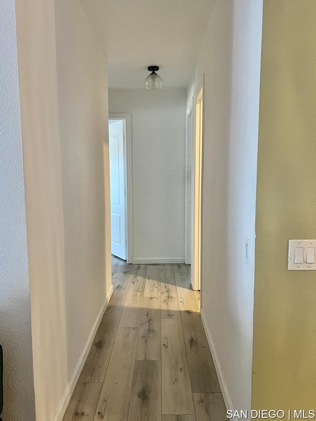 corridor with light wood-type flooring