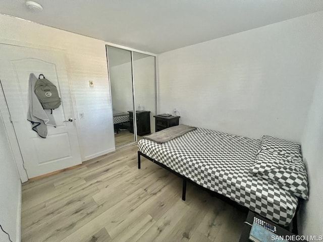 bedroom featuring light hardwood / wood-style floors and a closet