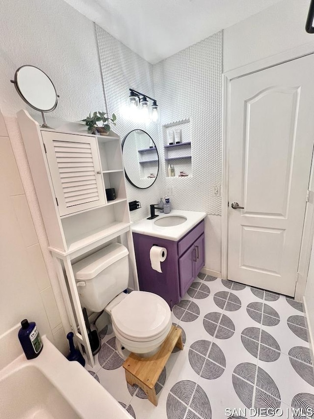 bathroom featuring tile patterned floors, vanity, and toilet