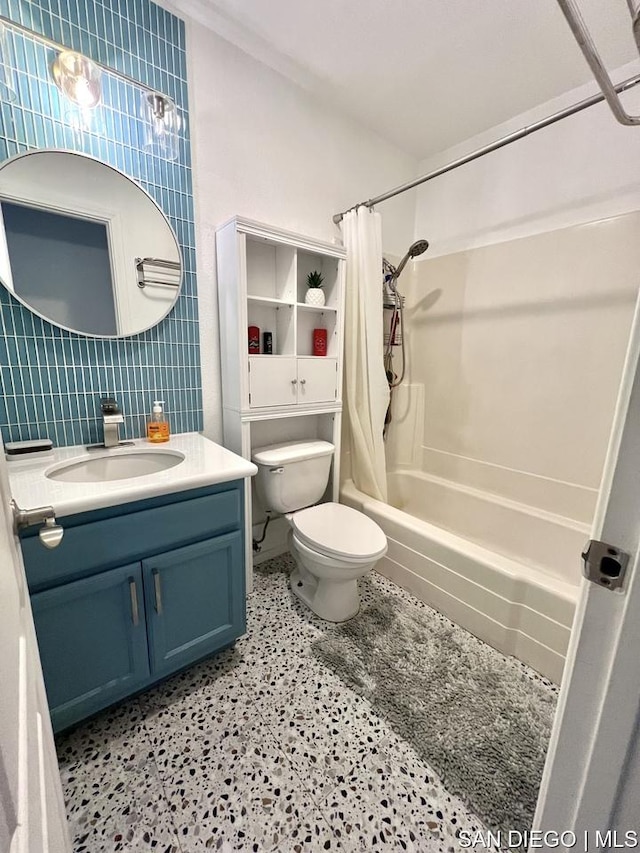 full bathroom with tile walls, backsplash, vanity, shower / tub combo, and toilet