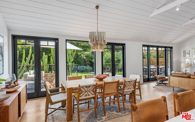 dining area featuring wood ceiling, french doors, a healthy amount of sunlight, and light hardwood / wood-style floors