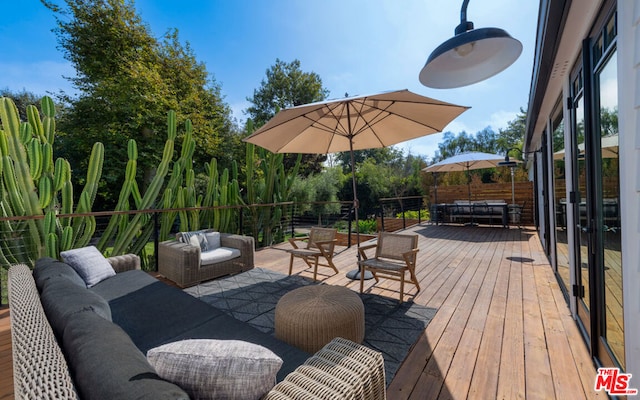 wooden terrace featuring an outdoor living space