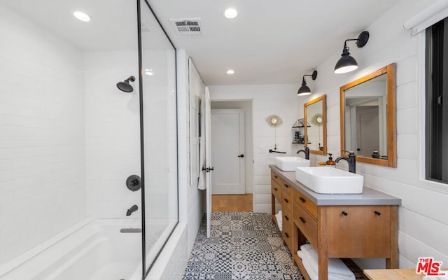 bathroom with vanity and tiled shower / bath combo