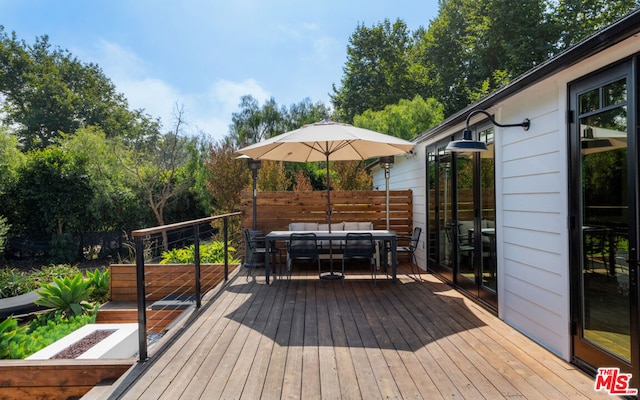 wooden terrace featuring outdoor lounge area