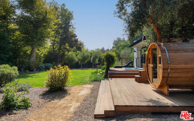 exterior space with a wooden deck and an outbuilding