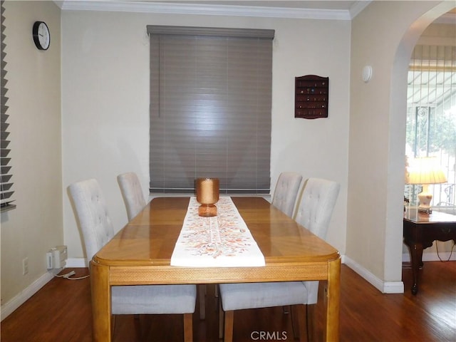 dining space featuring dark hardwood / wood-style flooring and crown molding