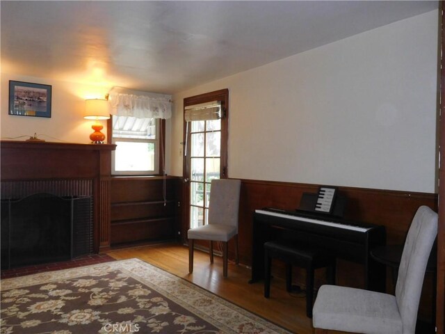 1415 Ximeno Ave, Long Beach, CA 90804 - living area featuring wainscoting, a fireplace, wood finished floors, and wooden walls