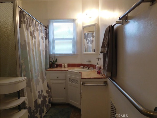 bathroom featuring vanity and walk in shower