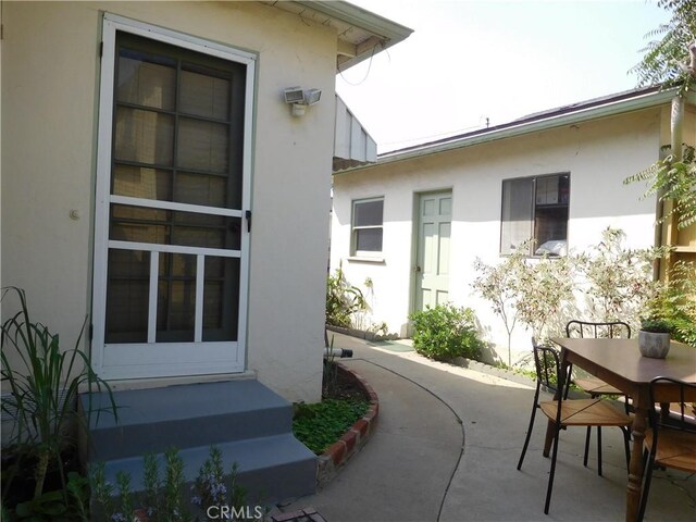 1415 Ximeno Ave, Long Beach, CA 90804 - view of property exterior featuring stucco siding, a patio area, and outdoor dining area