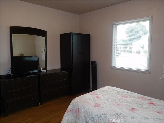 bedroom featuring hardwood / wood-style floors and multiple windows