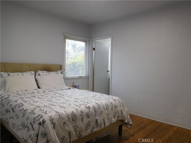 bedroom featuring dark hardwood / wood-style floors