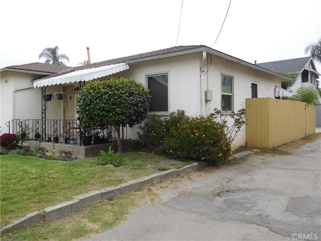 view of side of property with a lawn