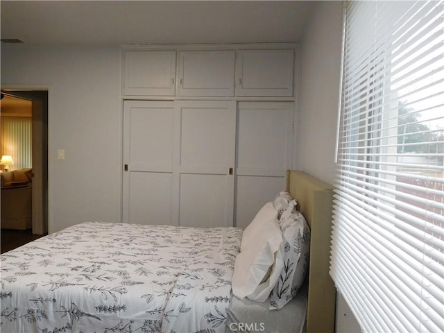 bedroom featuring dark hardwood / wood-style flooring and a closet