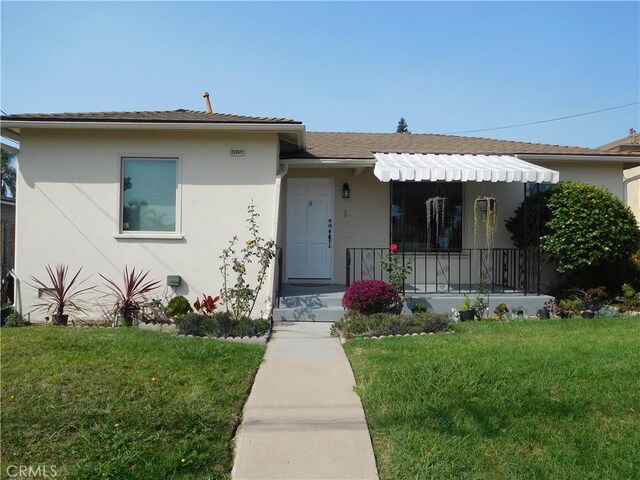 1415 Ximeno Ave, Long Beach, CA 90804 - view of front of home featuring stucco siding, a front yard, and covered porch