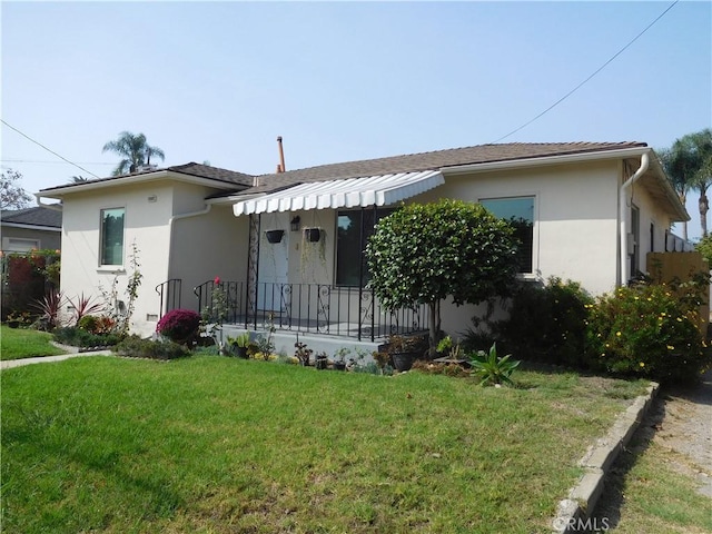 1415 Ximeno Ave, Long Beach, CA 90804 - view of front of property with stucco siding, a front yard, and covered porch
