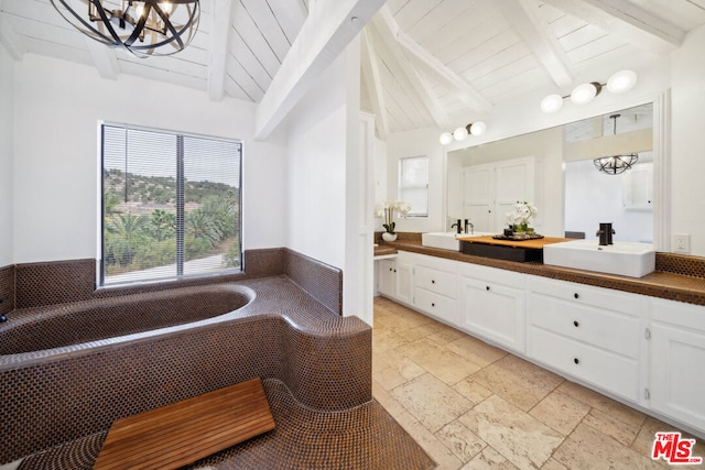 bathroom featuring vanity, a bathing tub, a chandelier, lofted ceiling with beams, and wooden ceiling