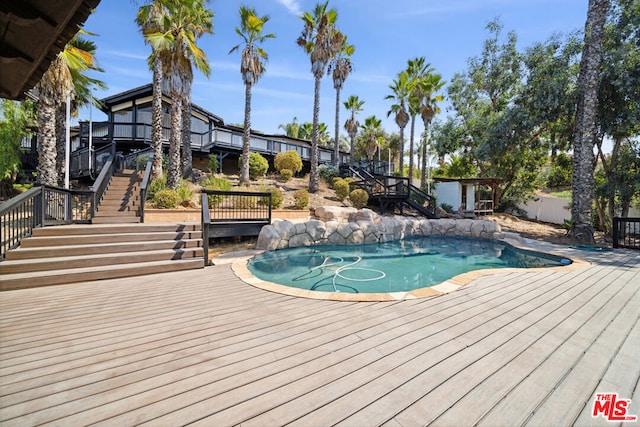 view of pool with a wooden deck