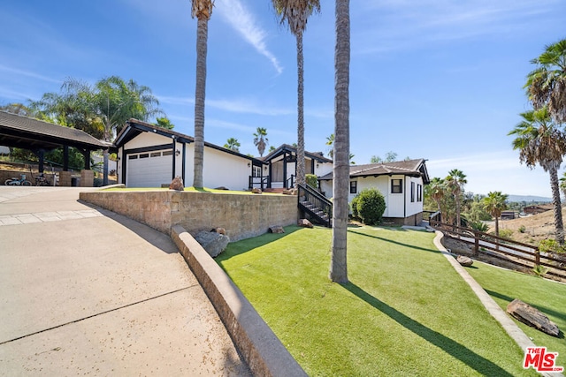 view of front of house with a front yard and a garage