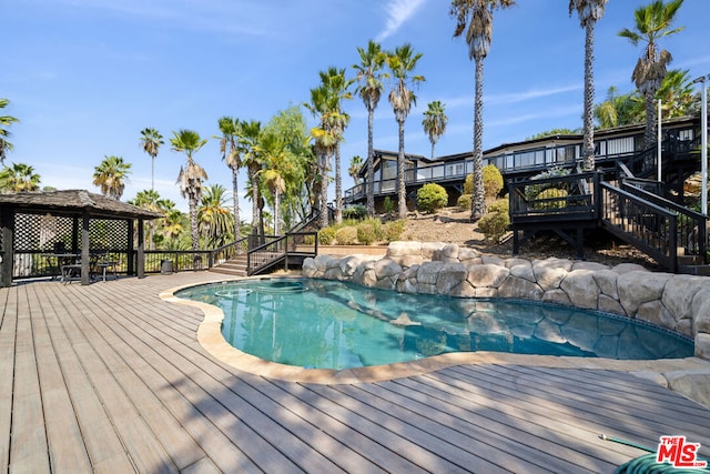 view of swimming pool featuring a gazebo and a wooden deck