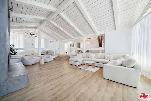 living room with vaulted ceiling with beams, a chandelier, and light hardwood / wood-style flooring