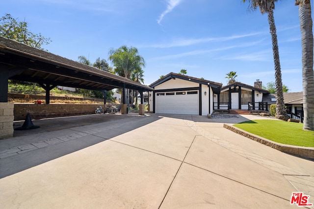 view of front of home featuring a front yard, a garage, and a carport