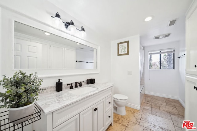 bathroom featuring vanity and toilet